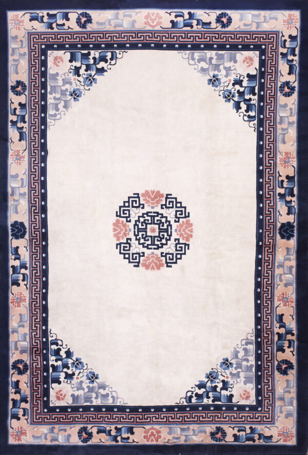 Rectangular cream rug with a navy, dusty rose, and blue floral border and a central geometric medallion.
