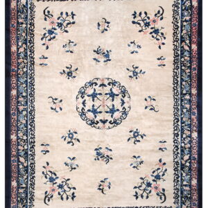Ivory high-sheen rug featuring scattered blue and pink floral motifs and complex navy blue multi-layered borders.