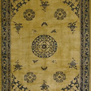 Gold rug featuring large navy blue medallions, scattered motifs, and an intricate dark border.
