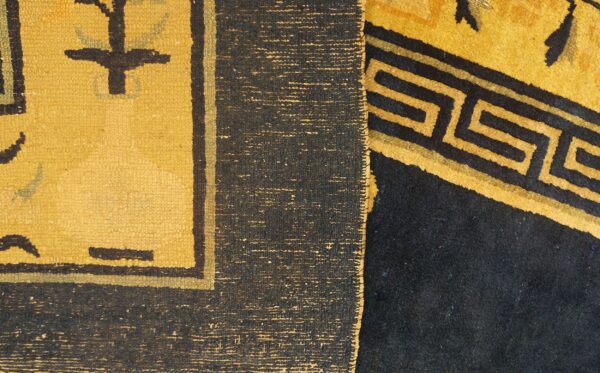 Detail showing flat yellow weaving with dark motifs beside a plush dark rug featuring a yellow greek key pattern.