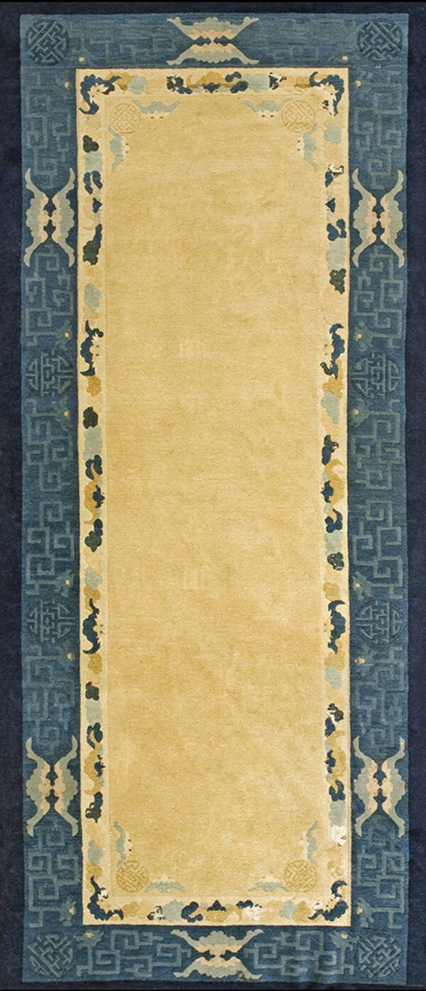 Gold runner rug featuring a wide, high-contrast blue border with geometric and stylized cloud motifs.