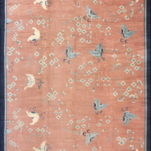 Rose-colored rug with light blue and cream butterflies and white flowers, enclosed by a thick navy border.