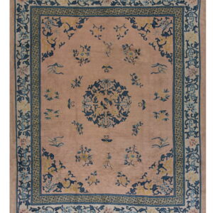 Mauve rug with a dark blue Greek key border and a central floral medallion pattern.