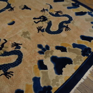 A high-pile rug with blue dragons, yellow, and taupe clouds on a peach background, bordered in navy.