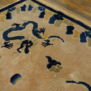 A high-pile rug with a navy dragon and multicolored cloud pattern rests on rustic wood plank flooring.