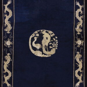 Dark blue rug featuring a light beige center medallion of birds and a wide repeating dragon border.