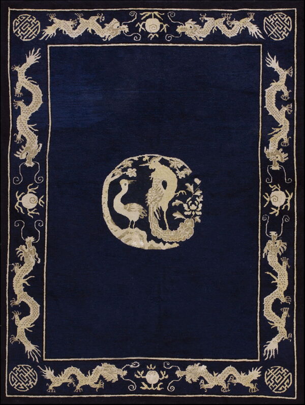 Dark blue rug featuring a light beige center medallion of birds and a wide repeating dragon border.