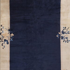 Rectangular rug with a deep navy center and a wide beige border featuring stylized blue and cream floral designs.