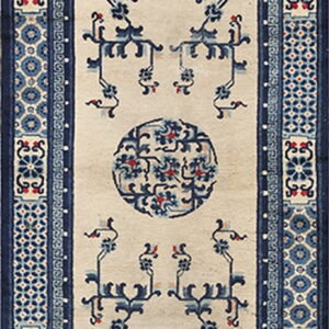 Low pile beige runner rug featuring symmetrical blue stylized motifs and complex patterned side borders.