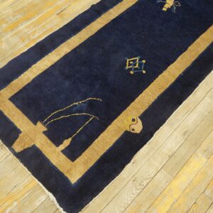 Dark blue wool hallway runner featuring a broad tan border and geometric motifs.