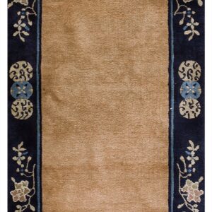 Long, plush runner rug in solid tan bordered by dark blue floral and medallion motifs.