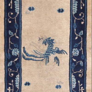 Long runner rug with a light beige field, deep blue border, and scattered stylized floral and bird designs.