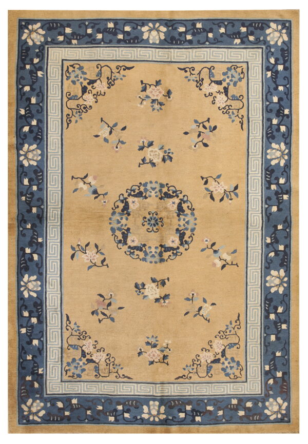 Tan rug with scattered pink and blue floral designs surrounded by a contrasting navy and light blue border.