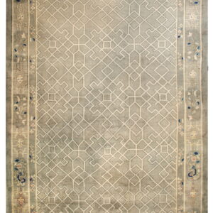 Grey rug with a complex light-colored geometric field and stylized floral and scroll borders in muted tones.