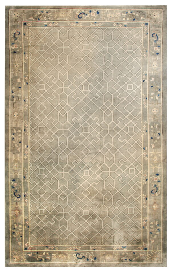 Grey rug with a complex light-colored geometric field and stylized floral and scroll borders in muted tones.