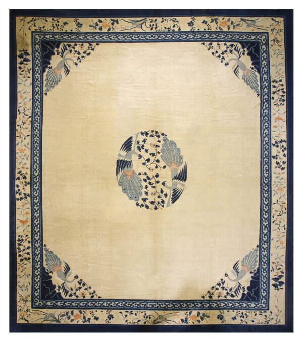 Cream area rug featuring navy and light blue bird and vine motifs in the center and corners.