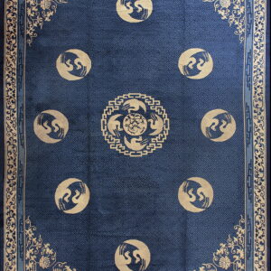 Deep blue rug with an interlocking lattice field and tan border featuring nine circular bird medallions.