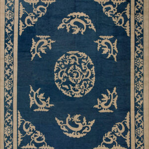 Traditional blue and tan rug with a central medallion, corner motifs, and elaborate floral borders.
