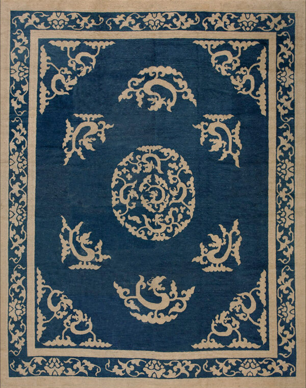 Traditional blue and tan rug with a central medallion, corner motifs, and elaborate floral borders.