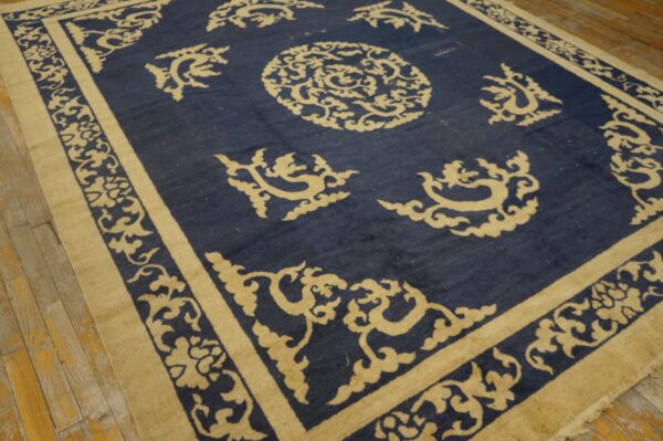 Low-pile rug featuring a large circular medallion and ornate beige motifs against a deep blue field.