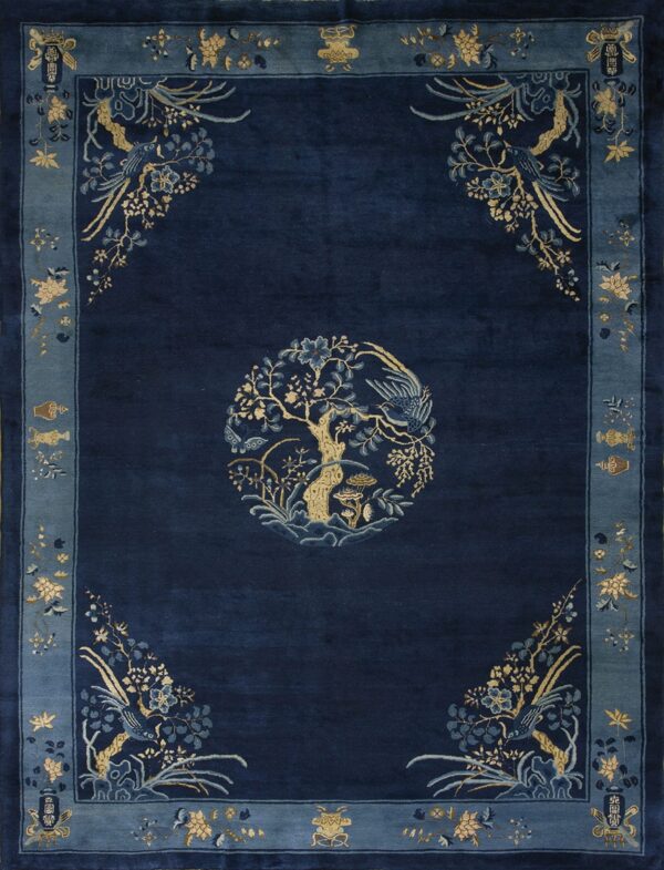 Deep navy rug with a gold and blue central tree medallion and figurative floral borders.