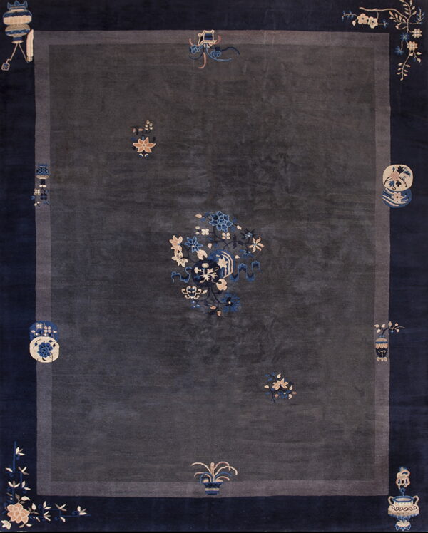 Dark gray rug with a wide navy blue border and scattered traditional motifs in cream and light blue.