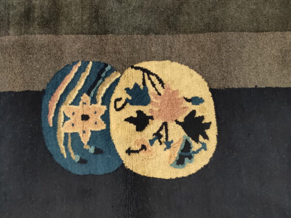Plush rug detail showing dark green and navy fields with round yellow and teal flower pattern accents.