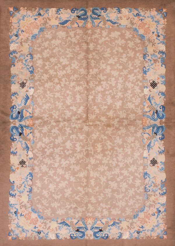 Rectangular low pile rug with a light brown field, mauve border, and colorful floral and bird patterns.
