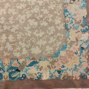 Mauve field rug with a delicate floral pattern and a corner design of vibrant turquoise birds and pink blooms.