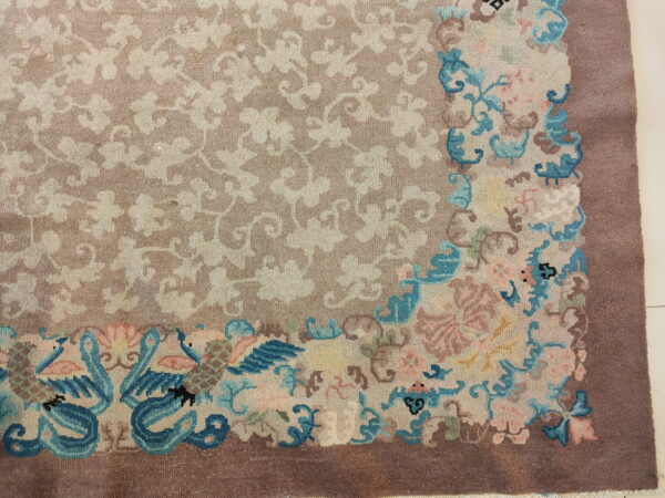 Mauve field rug with a delicate floral pattern and a corner design of vibrant turquoise birds and pink blooms.