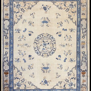 Cream rug with a blue and tan formal design, including a central medallion and ornate layered border.