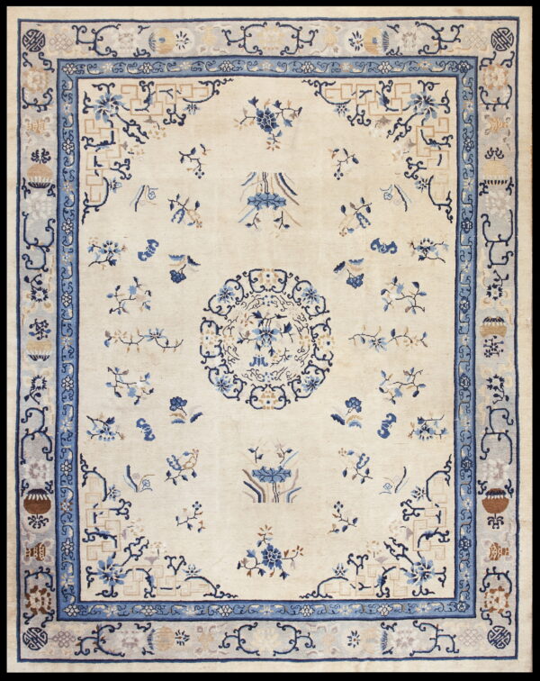 Cream rug with a blue and tan formal design, including a central medallion and ornate layered border.
