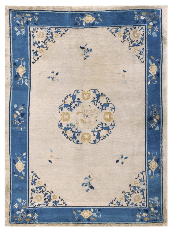Off-white area rug with a wide blue border and detailed blue and cream-colored floral designs.