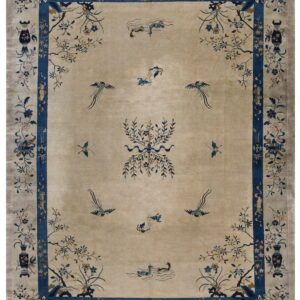 Tan field rug with a deep blue border and scattered detailed floral and bird designs.