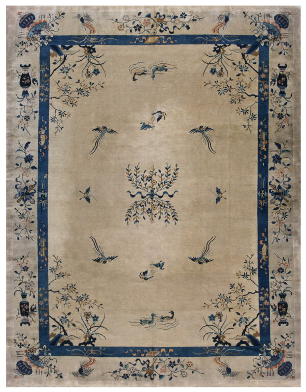 Tan field rug with a deep blue border and scattered detailed floral and bird designs.