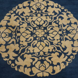 Deep blue rug featuring a large circular beige floral medallion and geometric motifs.