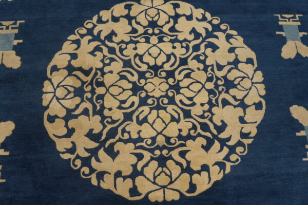 Deep blue rug featuring a large circular beige floral medallion and geometric motifs.