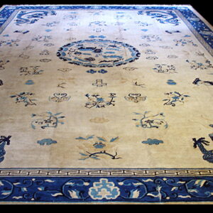 Ornate cream and blue rug featuring stylized dragons, a circular medallion, and detailed blue borders.
