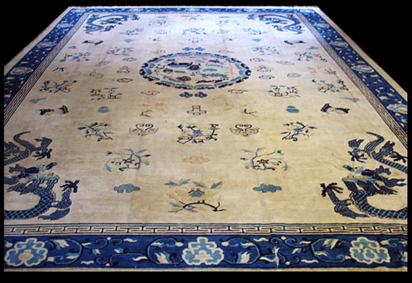 Ornate cream and blue rug featuring stylized dragons, a circular medallion, and detailed blue borders.