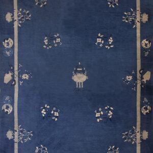 Deep indigo rug with a beige framed border and scattered stylized floral and vessel motifs.
