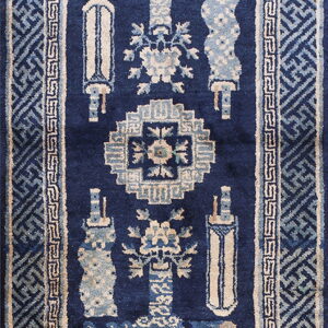 Navy blue runner with elaborate light blue and cream traditional motifs and wide geometric borders.