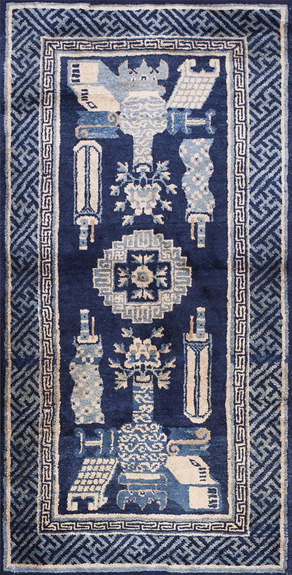 Navy blue runner with elaborate light blue and cream traditional motifs and wide geometric borders.