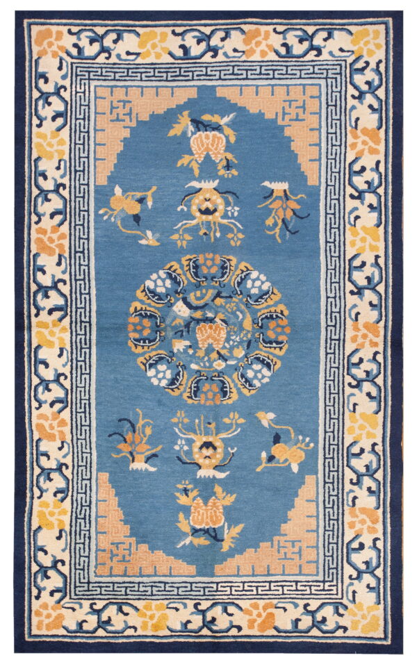 Blue rug with elaborate yellow and peach stylized patterns and multiple navy and ivory borders.