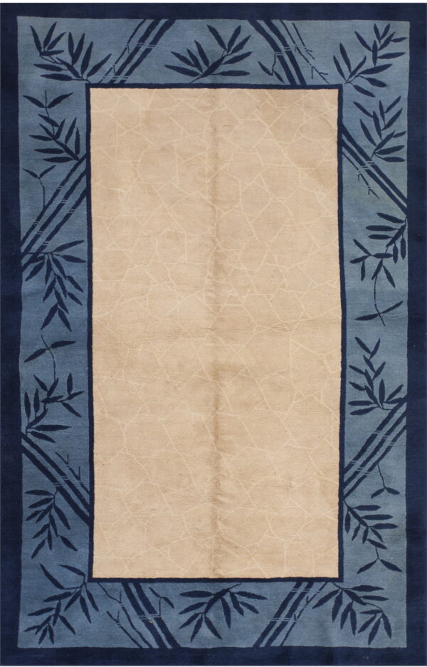 Beige rug with a light lattice pattern and a wide border of blue bamboo leaves and dark blue accents.