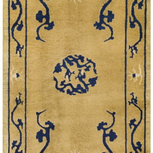 Medium pile gold rug featuring a navy blue and cream scrolling pattern, center medallion, and thick border.