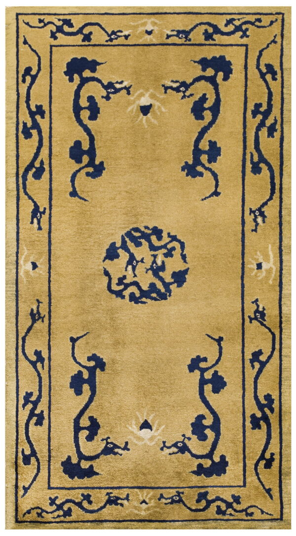 Medium pile gold rug featuring a navy blue and cream scrolling pattern, center medallion, and thick border.