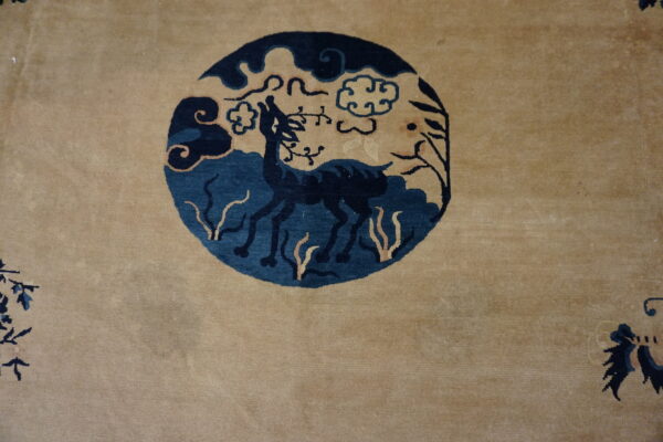 Deer motif on beige wool rug