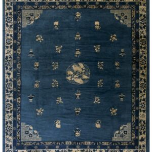 A deep blue rug featuring a central medallion, scattered tan designs, and complex ornamental borders.