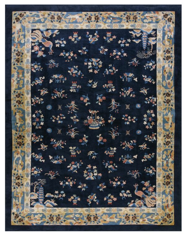 Navy blue rug with multicolored scattered motifs and a wide, detailed tan and blue border.