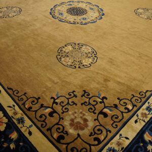 Plush golden brown rug with deep blue, beige, and tan floral medallions and ornate scroll borders.